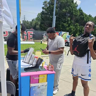 Customers stopping by the colorful BKrazy Lemonade cart outdoors