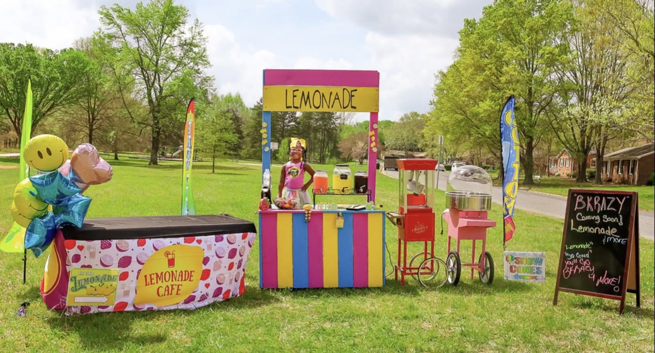 Brielle's colorful BKrazy Lemonade stand with balloons, popcorn and cotton-candy machines